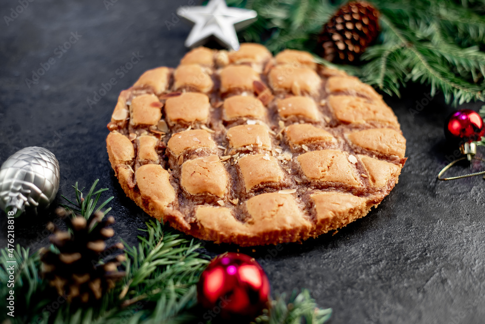 Christmas apple pie
with fir and new year decorations on a stone background Christmas apple pie
with fir and new year decorations on a stone background
