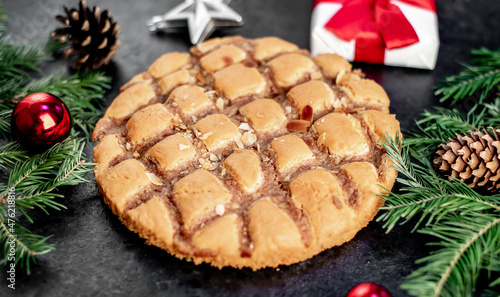 Christmas apple pie
 with fir and new year decorations on a stone background
