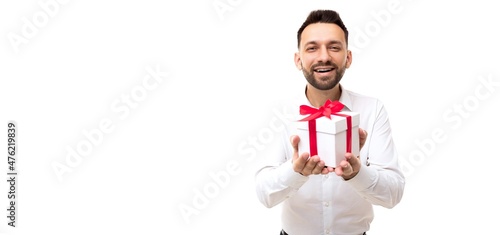 a man in a white shirt presents a box with a gift pulling it forward