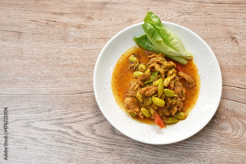 spicy stir fried twisted cluster bean with slice pork and cos lettuce on dish