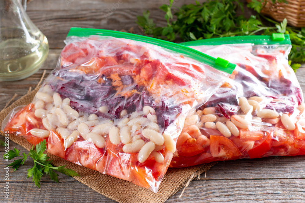 Plastic bags with different frozen vegetables on table Plastic bags with different frozen vegetables on table