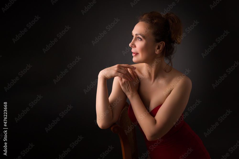 portrait of a sensual fifty year old woman on grey studio background portrait of a sensual fifty year old woman on grey studio background