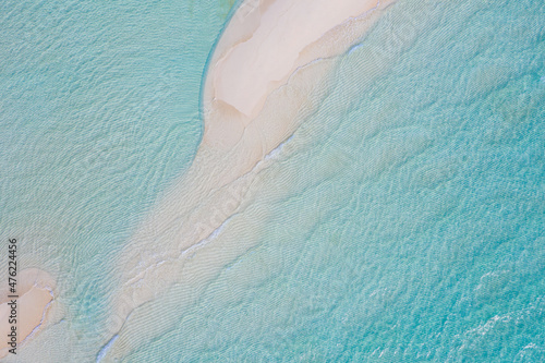 Aerial view of sandbar and blue sea. Maldivian sandbank in Indian ocean, white sandy coast crystal azure color water, perfect getaway for tropical vacations. Top aerial view, calm waves, surf relax