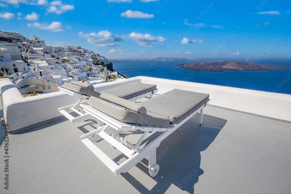 The sea view terrace at luxurious hotel, Santorini island, Greece. Luxury summer vacation background. Summer vacation at Santorini, chairs, loungers looking out over the Caldera. Empty couple scenic The sea view terrace at luxurious hotel, Santorini island, Greece. Luxury summer vacation background. Summer vacation at Santorini, chairs, loungers looking out over the Caldera. Empty couple scenic