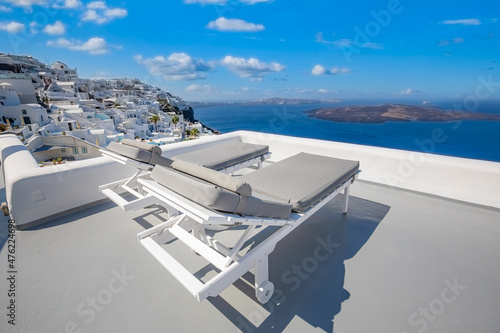 The sea view terrace at luxurious hotel, Santorini island, Greece. Luxury summer vacation background. Summer vacation at Santorini, chairs, loungers looking out over the Caldera. Empty couple scenic © icemanphotos