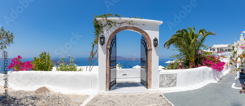 Fototapeta Naklejka Na Ścianę i Meble -  Fantastic travel panorama, Santorini urban street landscape. Blue door or gate stairs and white architecture sunny sky banner. Amazing summer vacation holiday adventure. Wonderful summer luxury vibes