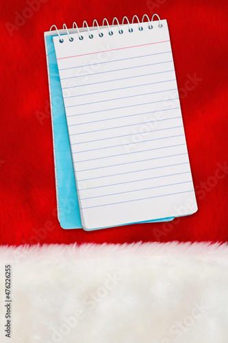 Christmas background with a notepad on white and red plush material