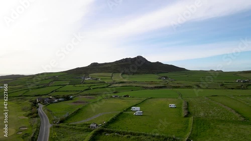 Green English countryside with Carn Llidi hill in the distance, Pembrokeshire in Wales. Aerial panoramic view photo