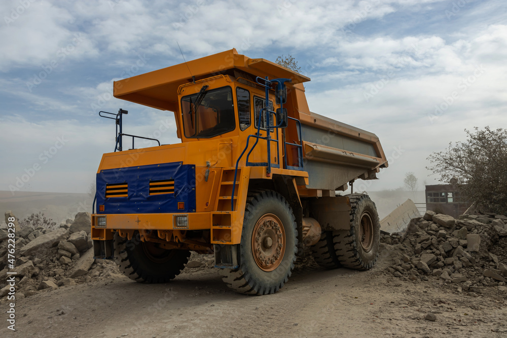 Large mining dump truck. Transport industry. Extraction of stone in an open pit Large mining dump truck. Transport industry. Extraction of stone in an open pit