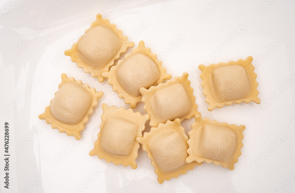 Ravioli pasta squares on a light white background. Ravioli pasta squares on a light white background.