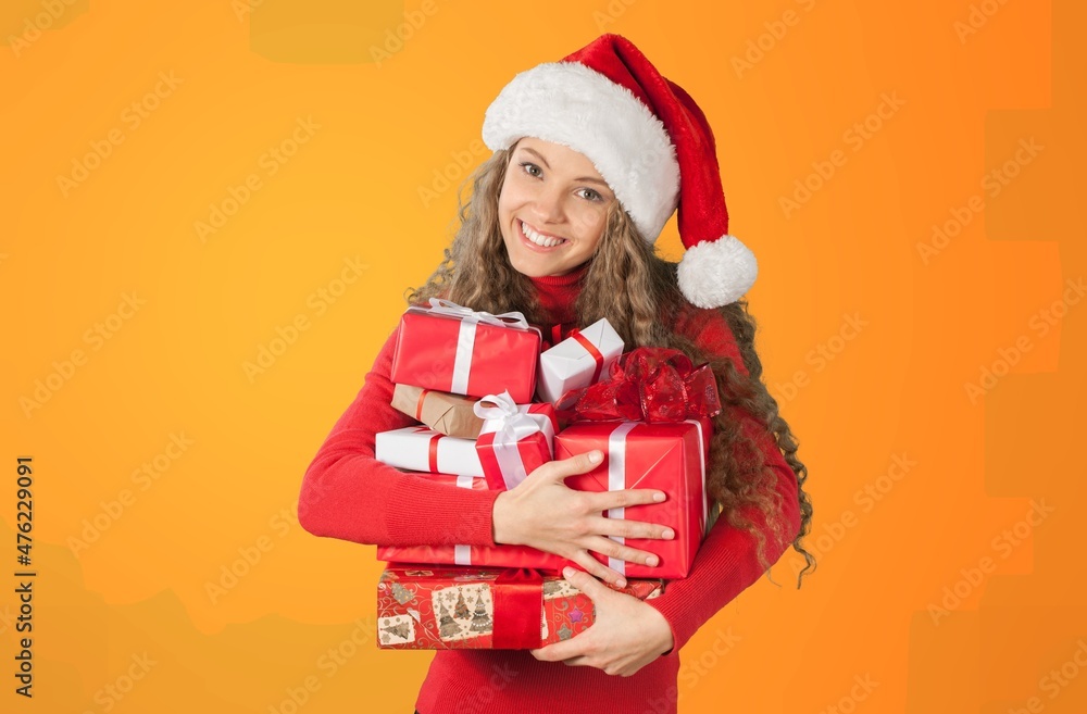 Young smiling happy pretty woman holding present boxes celebrating the new year, Christmas Young smiling happy pretty woman holding present boxes celebrating the new year, Christmas