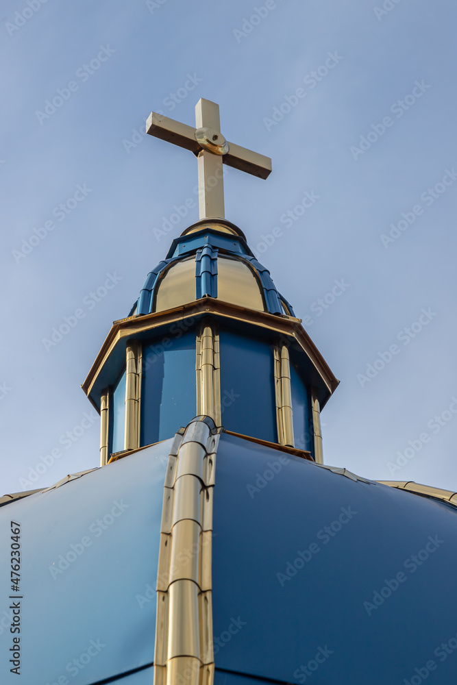 Close-up of a Cross on a Christian church on blue background