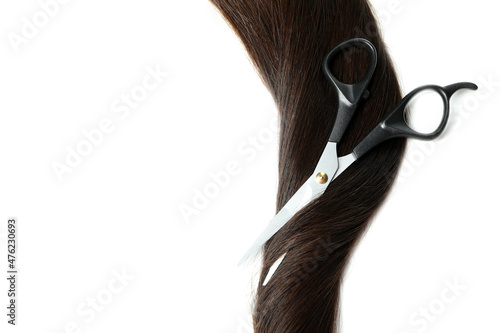 Female hair with scissors on white background