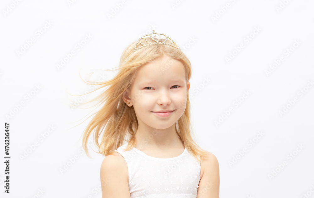 Funny little princess girl in silver crown and white dress over white background Funny little princess girl in silver crown and white dress over white background