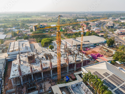 Aerial view of building crane on construction site and have communities and cities around. #476237202