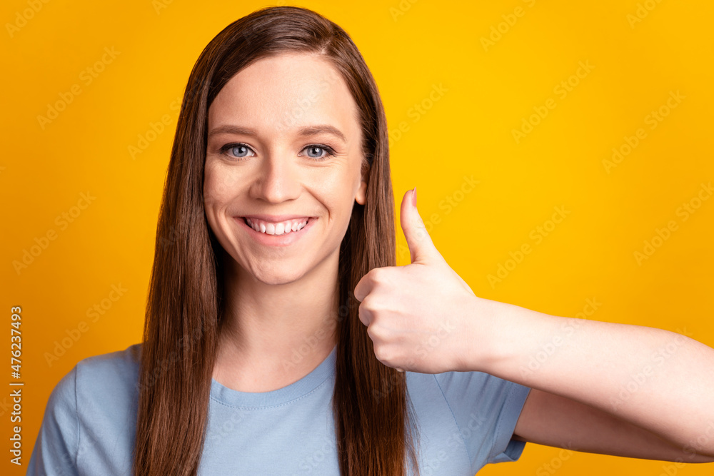 Photo of young cheerful woman show thumb-up ideal advertise choice isolated over yellow color background Photo of young cheerful woman show thumb-up ideal advertise choice isolated over yellow color background
