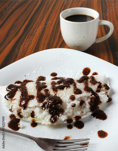 Closeup of sweet tapioca, chocolate and cooconut, black coffee cup in the background photo