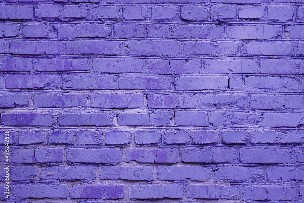 Fototapeta premium Fragment of street brick wall toned in trendy color of the 2022 year