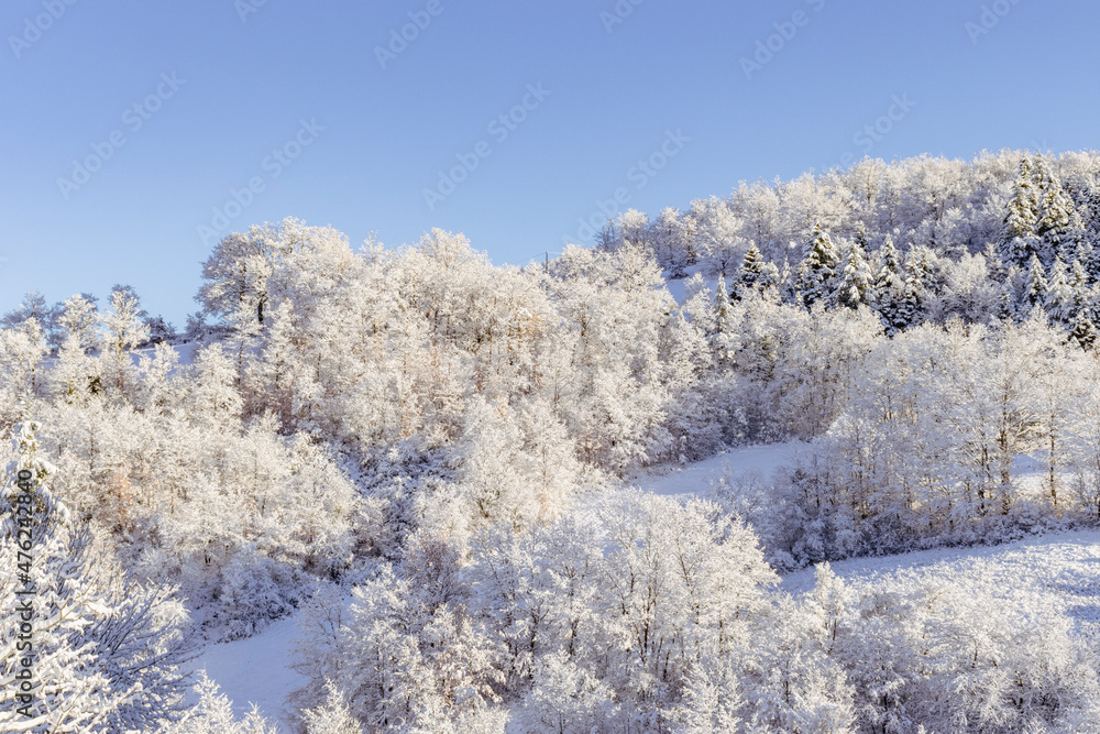 High angle view of snow capped mountains and vegetation. Clear sky. Tuscan-Emilian Apennines, Italy. Copy space. High angle view of snow capped mountains and vegetation. Clear sky. Tuscan-Emilian Apennines, Italy. Copy space.