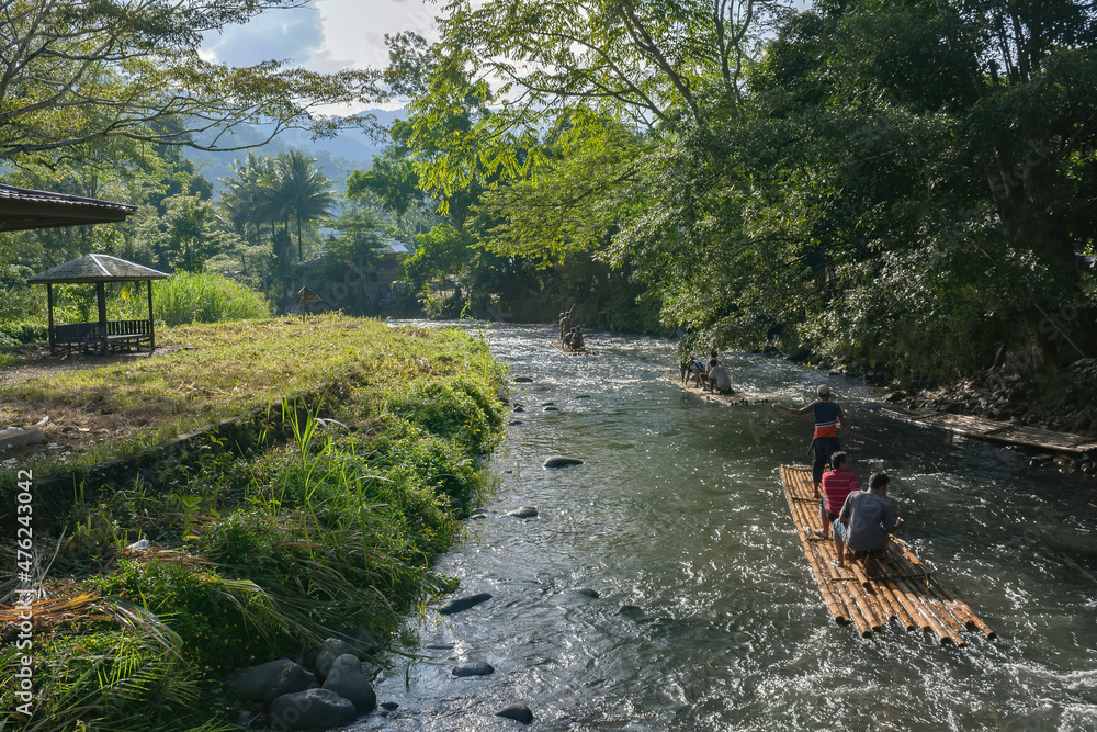 The local tourists, doing rafting activities on the Amandit river, enjoy the beautiful atmosphere and social culture along the Amandit river in the morning, South Borneo.