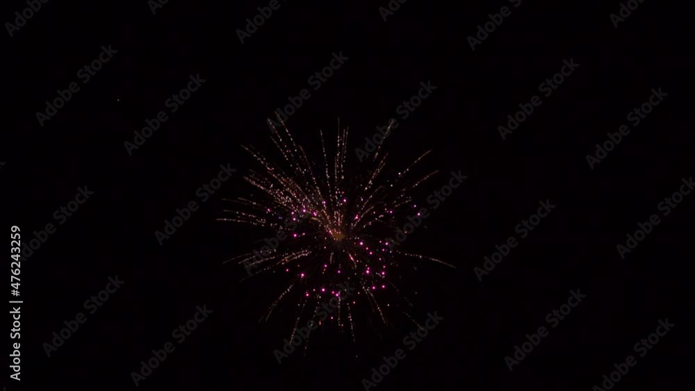 Handheld slow motion shot firework in the sky during the new year celebration. Background for new year party. Shining fireworks with bokeh. New year's eve firework celebration. Handheld slow motion shot firework in the sky during the new year celebration. Background for new year party. Shining fireworks with bokeh. New year's eve firework celebration.