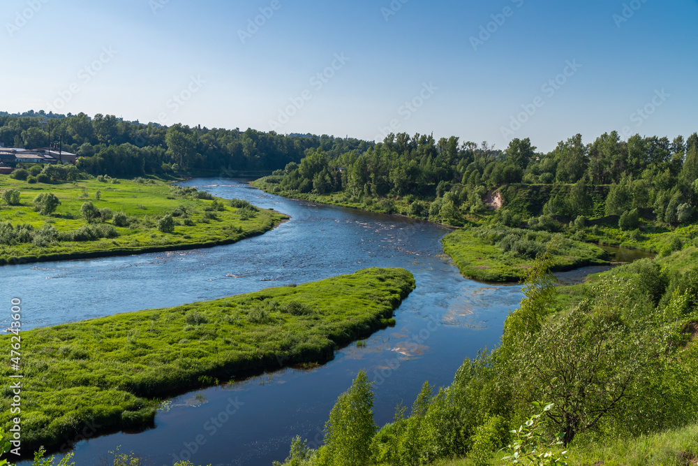 Russia. June 20, 2021. Picturesque view of the Msta river in sunny weather.