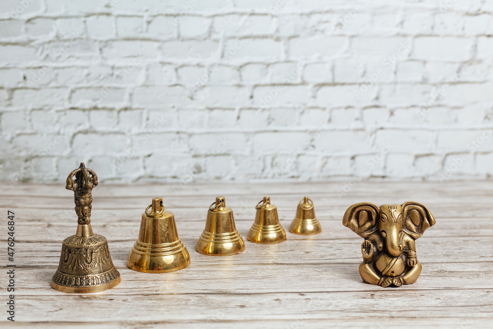Bronze statue of Lord Ganesha, hindu God. Set of metal bells for