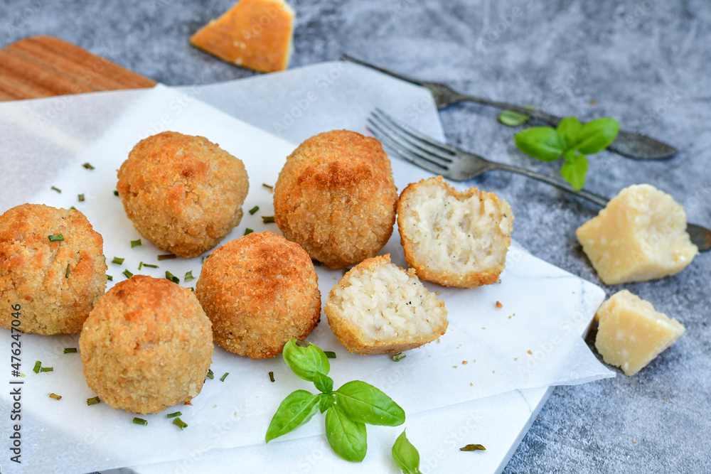 Italian arancini Cacio e pepe. Homemade rice balls with mozzarella cheese, parsley, lemon, and