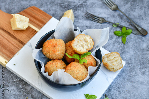 Italian arancini Cacio e pepe. Home-made rice balls with mozzarella cheese, parsley, lemon, and parmesan cheese.