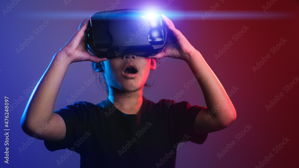happy girl in glasses of virtual reality. Augmented reality, science, future technology concept. VR. Futuristic 3d glasses with virtual projection. Neon light. happy girl in glasses of virtual reality. Augmented reality, science, future technology concept. VR. Futuristic 3d glasses with virtual projection. Neon light.