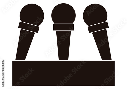 Icono negro de micrófonos para rueda de prensa. 