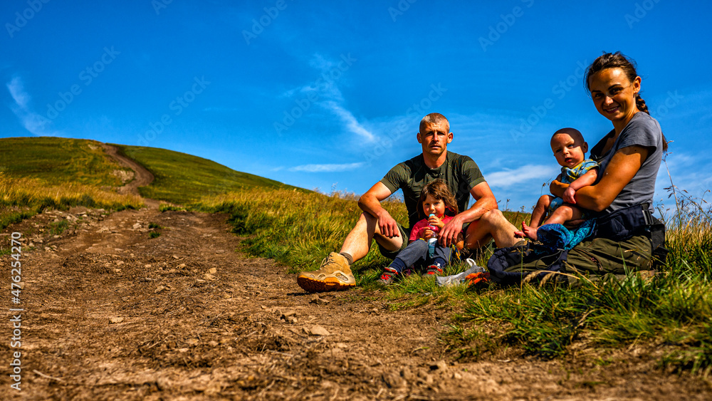 Family resting in a mountain meadow. Family resting in a mountain meadow.