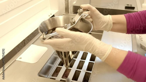 A female pouring ice cream mixture into the molder in 4K