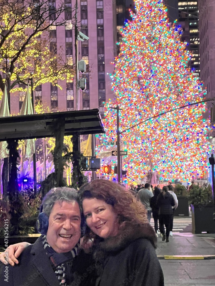 couple in love in front of a christmas tree outdoors