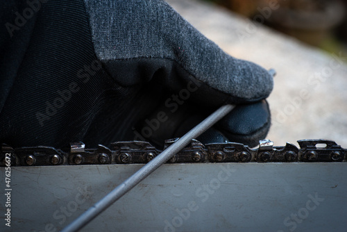 hand sharpening a chain saw blade with a round file . do it your self .