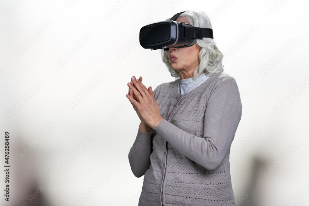 Old caucasian woman wearing virtual reality goggles. Old caucasian woman wearing virtual reality goggles.