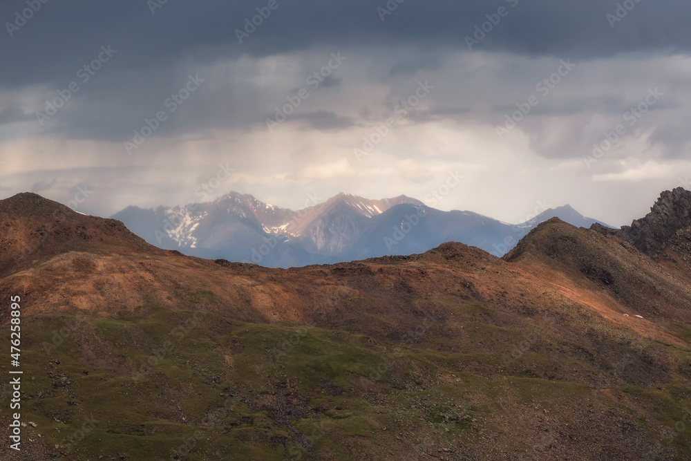 Landscape on the rainy high plateau. Dramatic sky on mountain peaks. Mystical background with dramatic mountains.