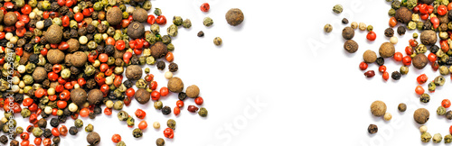 Black, red and white pepper grains isolated on white. Spice. Panorama. Banner.