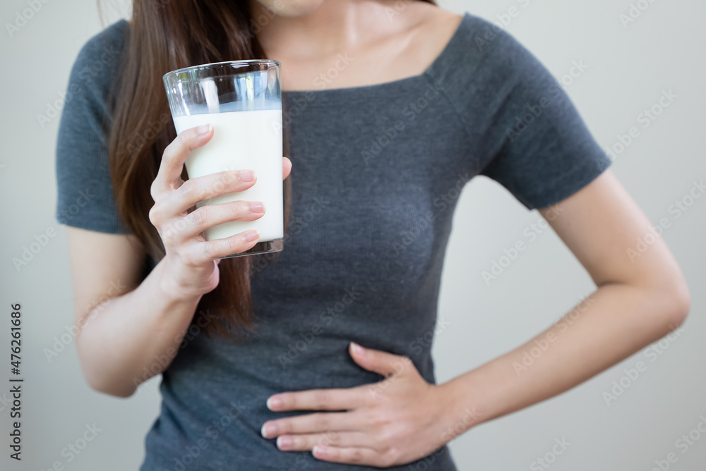 lactose intolerance concept. Woman having a stomachache because drink milk. lactose intolerance concept. Woman having a stomachache because drink milk.