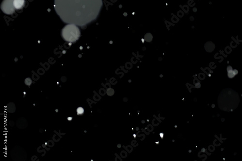 A texture of blurred snowflakes during the snowstorm in the dark © Yurii Klymko