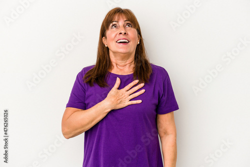 Middle age caucasian woman isolated on white background laughs out loudly keeping hand on chest.