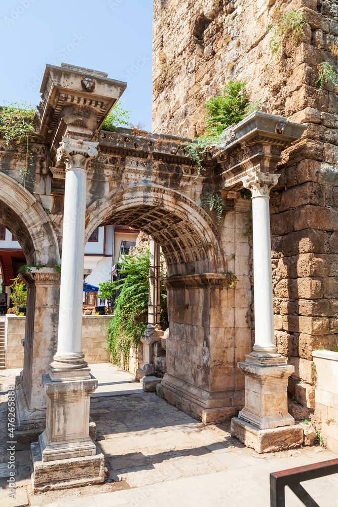 Column and arch of a famous tourist and archaeological site of Antalya is The Emperor Hadrian's gate in the old city. Travel destinations and vacation in Turkey