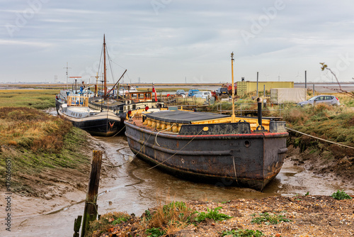 Barges and Boats grounded at Low Tide on the River Medway Estuary at Upchurch in Kent  England