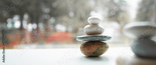 Photography Zen rocks stacked on the white promenade near tranquil pond in the autumn woods