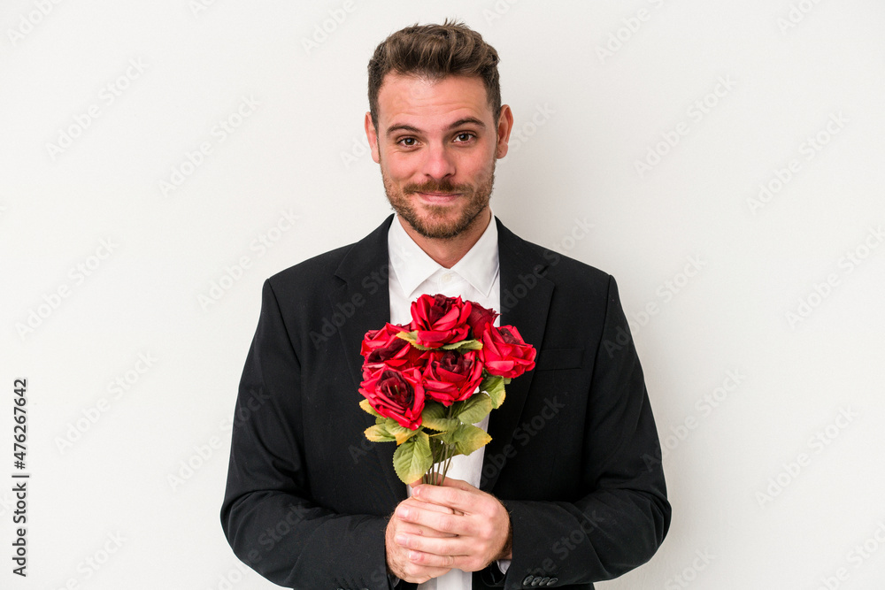 Young caucasian man holding bouquet of flowers isolated on white background Young caucasian man holding bouquet of flowers isolated on white background