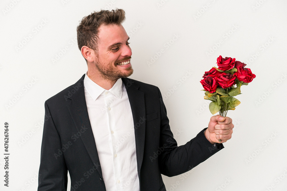 Young caucasian man holding bouquet of flowers isolated on white background Young caucasian man holding bouquet of flowers isolated on white background