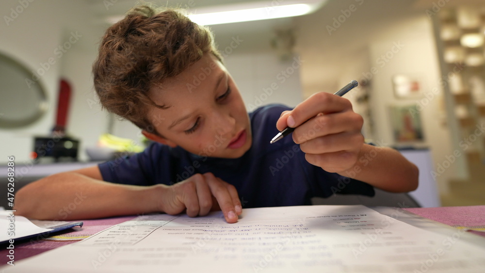 Naklejka premium Young boy doing homework after school. Kid preparing for exam