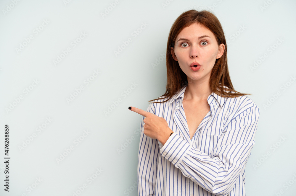 Young English woman isolated on blue background pointing to the side Young English woman isolated on blue background pointing to the side