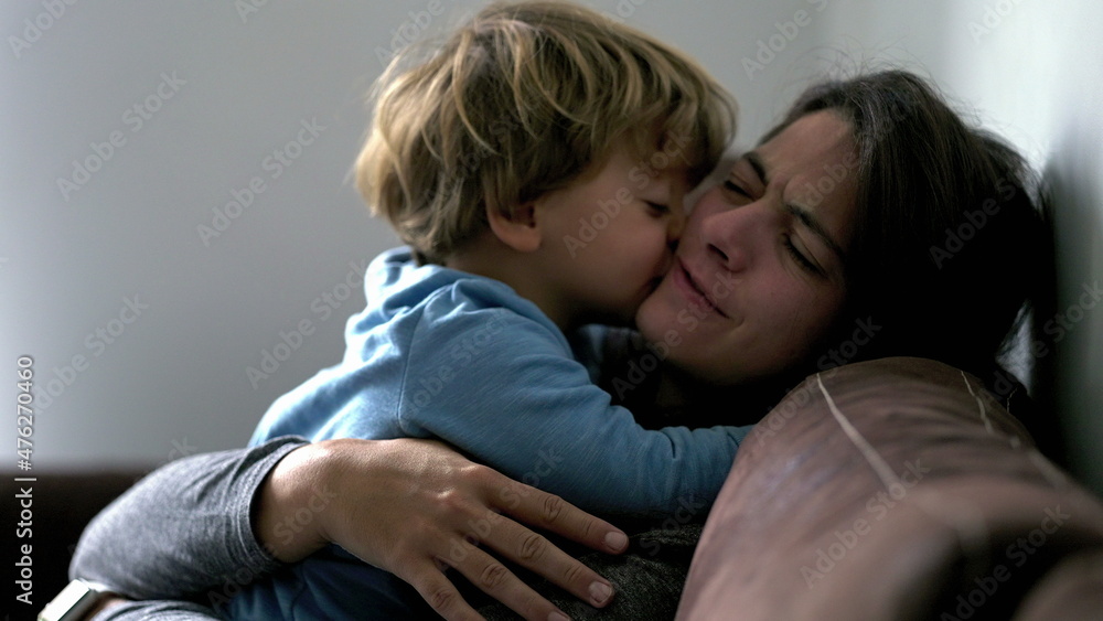 Mother and child authentic love and affection moment, son embracing mom Mother and child authentic love and affection moment, son embracing mom