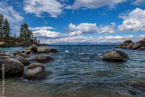 Lake Tahoe with rocks under the bright sky with clouds in Stateline, Nevada, USA photo